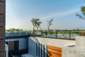a view from the balcony of a building with chairs at Body Factory Lifestyle Residence Uluwatu in Uluwatu