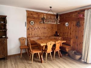 a dining room with a wooden table and chairs at Chesa Chatrigna App 6 - Celerina in Celerina