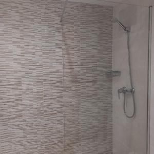 a bathroom with a shower with a glass door at Costa d'Or SALOU in Salou +9 photos