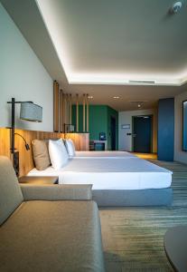 a large bedroom with a large bed and a couch at HVD Reina del Mar - Premium Spa Service & Free Parking in Obzor