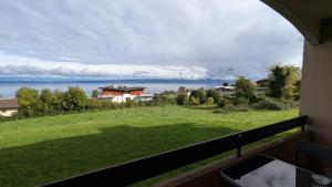 a view of the water from the balcony of a house at Le Panoramic Evian in Évian-les-Bains