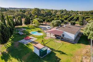 an aerial view of a house with a pool and a yard at La Huerta Del Prado in Arcos de la Frontera