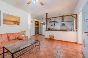 a living room with a couch and a glass table at La Huerta Del Prado in Arcos de la Frontera