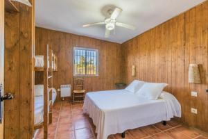 a bedroom with a bed and a ceiling fan at La Huerta Del Prado in Arcos de la Frontera