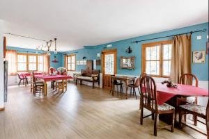 una sala da pranzo e un soggiorno con tavoli e sedie di Casa Rural Hostel dos Lucas a Biescas