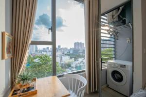 a apartment with a balcony with a washing machine at DFour River Gate Deluxe Apartment by the River in Ho Chi Minh City