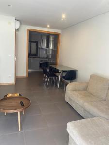 a living room with a couch and a table at Cisa home in Prainha +5 photos