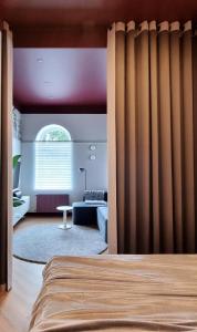a bedroom with a bed and a living room at Violet Lux Apartment in Daugavpils +6 photos