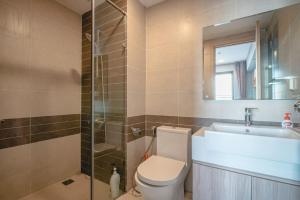 a bathroom with a toilet and a sink and a shower at DFour River Gate Deluxe Apartment by the River in Ho Chi Minh City +56 photos