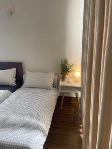 a bedroom with two beds and a table with a plant at Mộc miên homestay & coffee dốc lết 