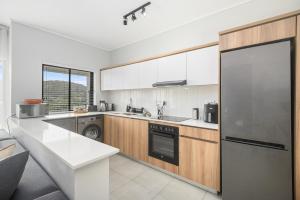 a kitchen with a refrigerator and a dishwasher at Ballito Hills 824 in Ballito