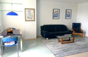 a living room with a couch and a table at stan/apartman s pogledom in Sarajevo +2 photos