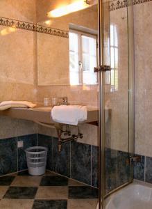 a bathroom with a sink and a shower at Gästehaus Hartweger in Haus im Ennstal