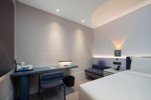 Ένα ή περισσότερα κρεβάτια σε δωμάτιο στο Light Atour Hotel Changsha Hunan Museum Xiangya Hospital Metro Station