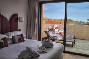 two women sitting in a chair in a hotel room at Hôtel & Spa Rocabella in LʼÎle-Rousse +49 photos