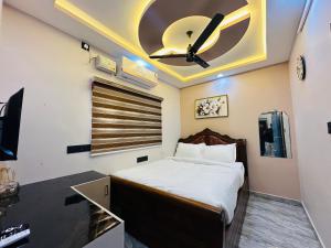 a bedroom with a bed and a ceiling fan at North paradise in Cochin