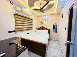 a bedroom with a bed and a ceiling fan at North paradise in Cochin