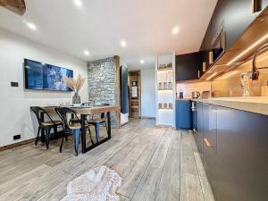a kitchen and dining room with a table and a counter at Modern 2BR Apt with Mountain Views & Private Parking in Les Houches