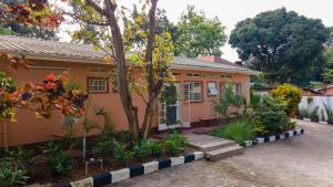 a house with a garden in front of it at Kara Space BnB in Kampala +30 photos