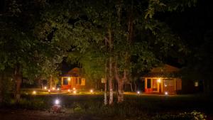 a house at night with lights in front of it at Wild Haven Resort Bandhavgarh in Tāla