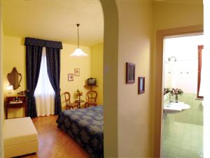 Postel nebo postele na pokoji v ubytování Hotel Ristorante Piccolo Chianti