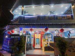 a house decorated with christmas lights and decorations at SunStar Hotel in Kampong Batu Maung