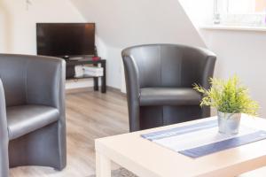 Televiisor ja/või meelelahutuskeskus majutusasutuses Hamburger Str 24 FeWo Möwe 4