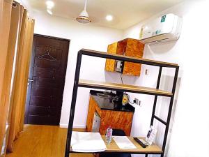 a room with a shelf and a kitchen with a refrigerator at Yet Shipping Container in Christiansborg +4 photos