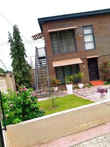 a house with a staircase in the front yard at Yet Shipping Container in Christiansborg