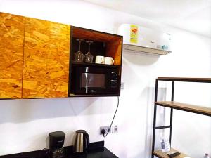 a kitchen with a microwave on a wall at Yet Shipping Container in Christiansborg