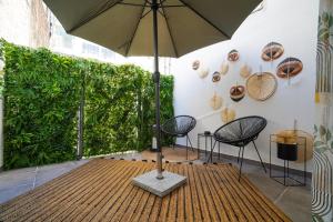 a table with an umbrella in a room with chairs at Love room & Spa in Larisa