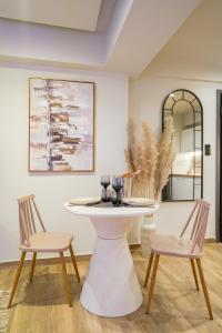 a dining room with a table and two chairs at Love room & Spa in Larisa