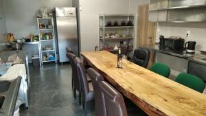 a dining room with a wooden table and chairs at Chata dobrý pocit in Horné Orešany