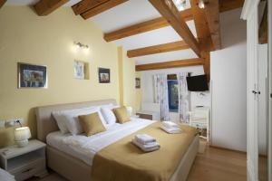 a bedroom with a large bed with two towels on it at Holiday house Katarina in Barban +47 photos
