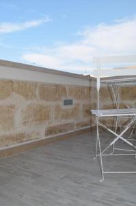 a table and a chair sitting on a patio at dimore cieli di dante in Conversano