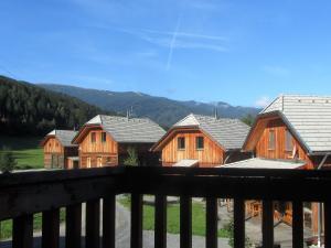 a group of wooden houses with mountains in the background at Chalet in St Georgen ob Murau nahe Skigebiet in Sankt Georgen ob Murau +36 photos