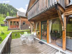 a wooden deck with a table and chairs at Chalet in St Georgen ob Murau nahe Skigebiet in Sankt Georgen ob Murau
