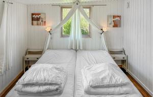 a bed in a room with a window at Pet Friendly Home In Faxe Ladeplads With Wifi in Vallebo