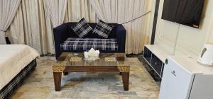 a living room with a couch and a coffee table at White House Karachi in Karachi
