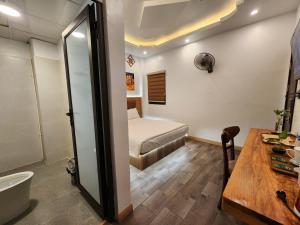 a bathroom with a bed and a sink in a room at Thành Nam Hotel in Dien Bien Phu