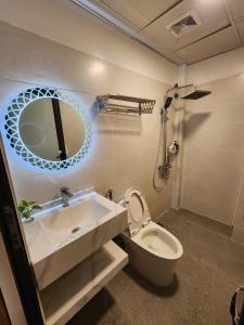 a bathroom with a sink and a toilet and a mirror at Thành Nam Hotel in Dien Bien Phu