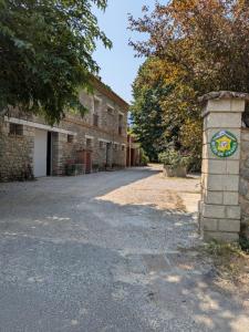a building with a sign on the side of a road at El Paller Mas Vidalou in Céret