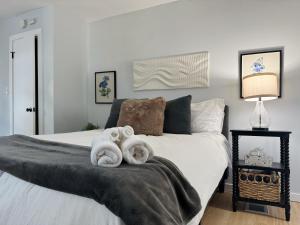 a bedroom with a bed with towels on it at Chandler Studio Apartments in Evansville