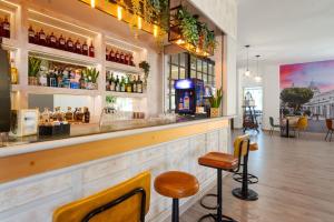 a bar with two stools in front of it at Il Gelso Bianco in Misterbianco