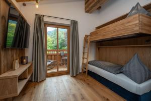 a bedroom with a bunk bed and a desk at Haus Eder in Saalfelden am Steinernen Meer