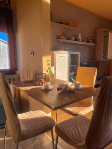 a kitchen with a wooden table with chairs and a tableasteryasteryasteryasteryastery at Apartment Vesna in Supetarska Draga