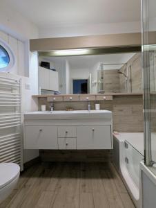 a bathroom with a sink and a toilet and a mirror at Billy Avoriaz - Chalet Mont Oya in Morzine +24 photos