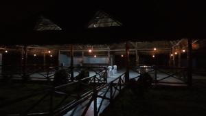 a night view of a building with lights at Wayma Paradise Resort in Jambiani +8 photos