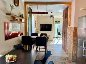 a kitchen and living room with a table and chairs at Cozy village in Ikšķile