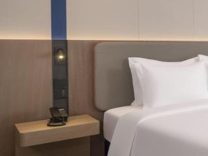Ένα ή περισσότερα κρεβάτια σε δωμάτιο στο Holiday Inn Express Aksu by IHG